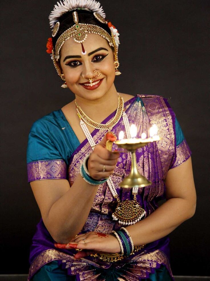 Bharatnatyam girl with grace beauty doing arti in hindu culture